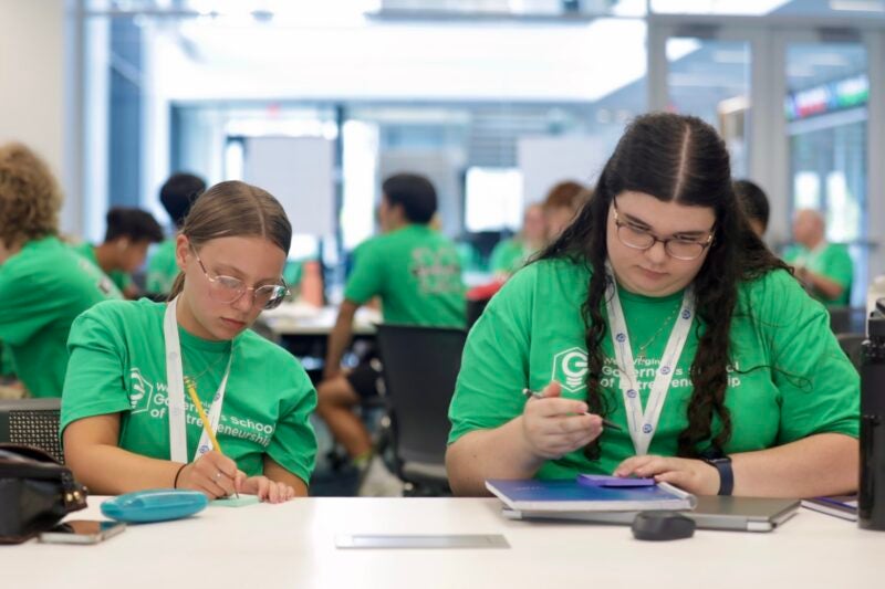 Students at a table working on a project