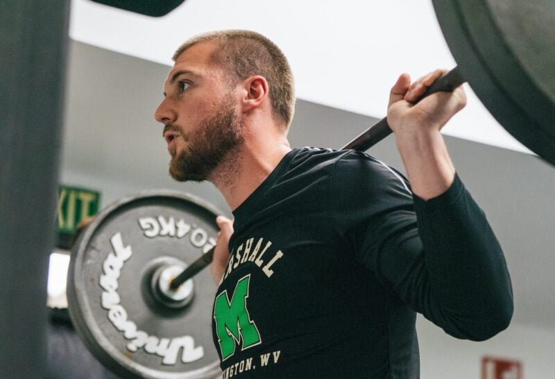 student squatting during a weightlifting exercise