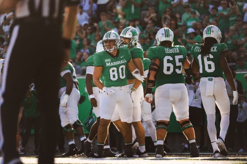 football players on the sideline of a football game