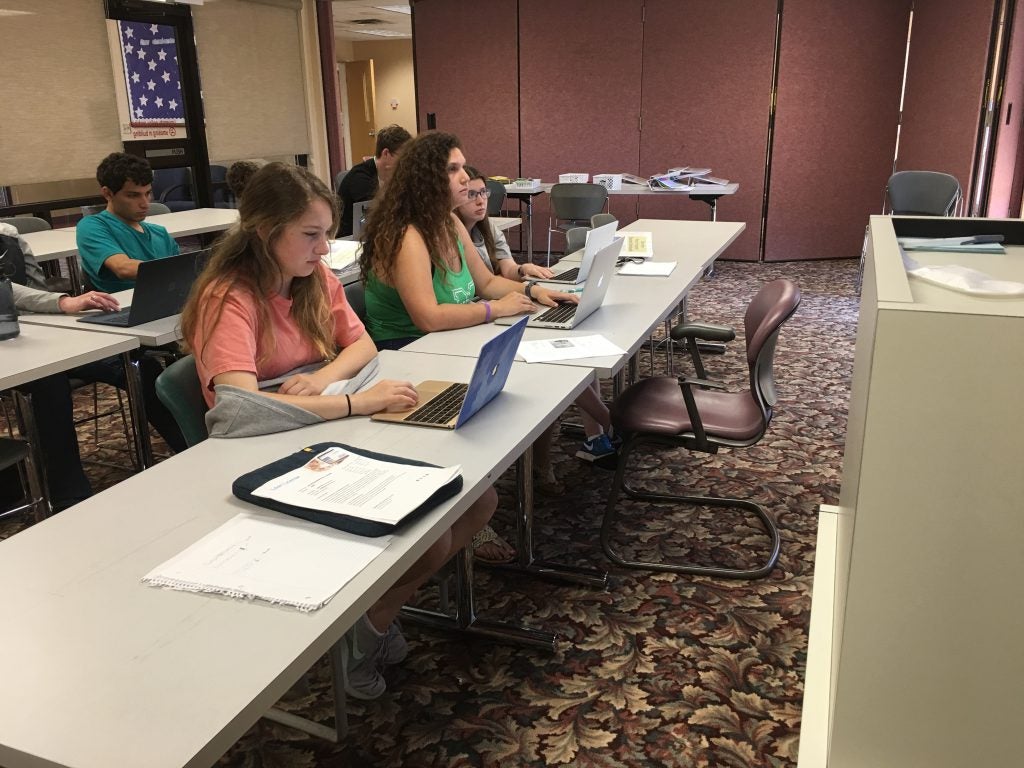 Incoming students listen to a lecture in the Heiner Study Room.