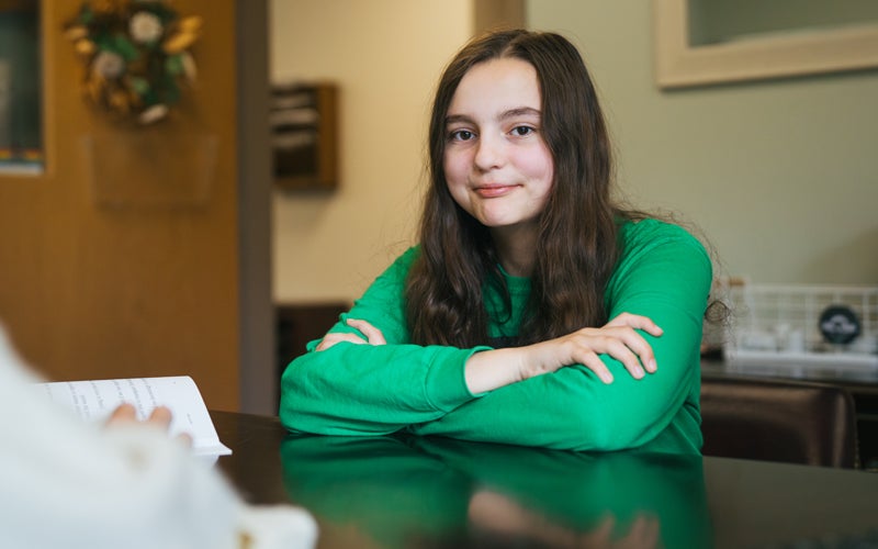 A young student meets with Marshall University HELP Center staff