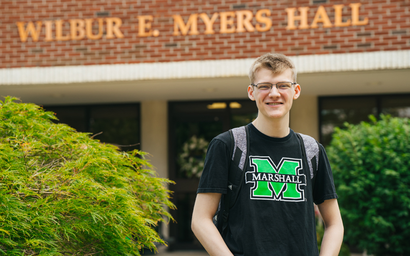 A College HELP student stands outside of the HELP Center at Marshall University