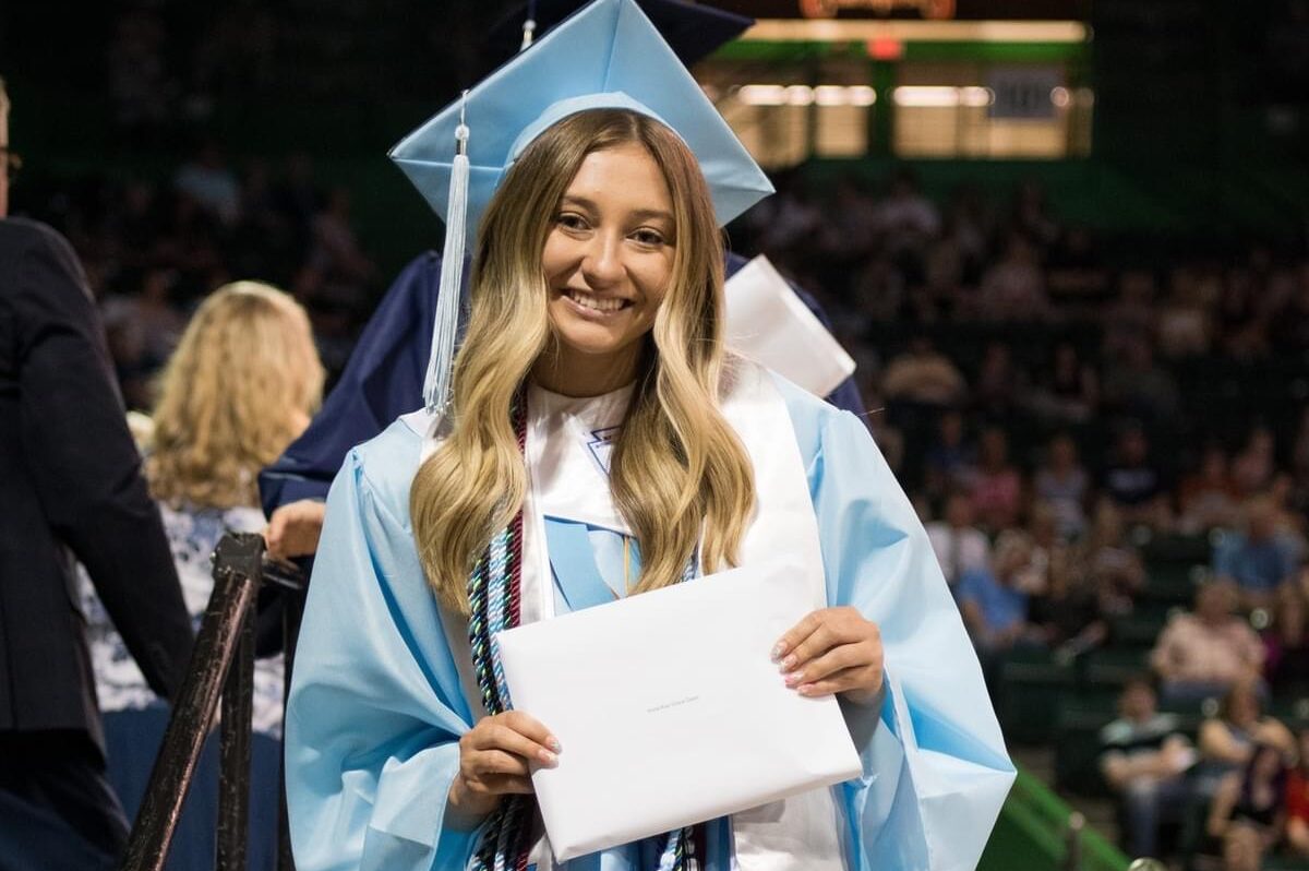 Anna-Kay Dean holder her diploma as she crosses the stage during her Spring Valley High School graduation ceremony.