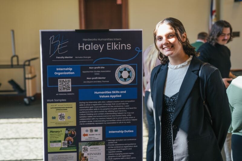 student presenting a poster at an internship fair