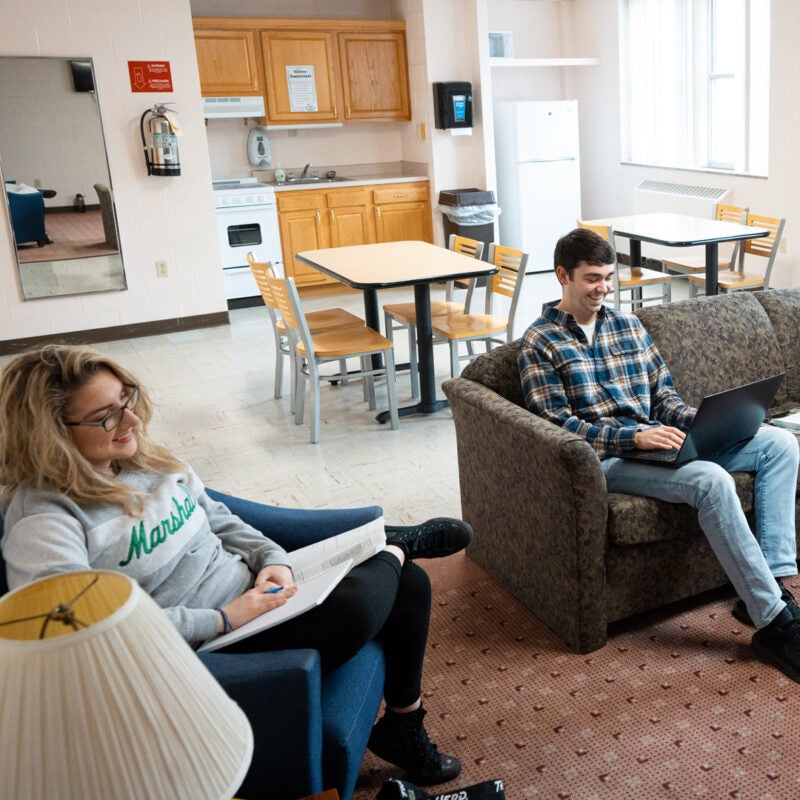 Students study in a kitchen and lounge area in Marshall University's Buskirk Hall