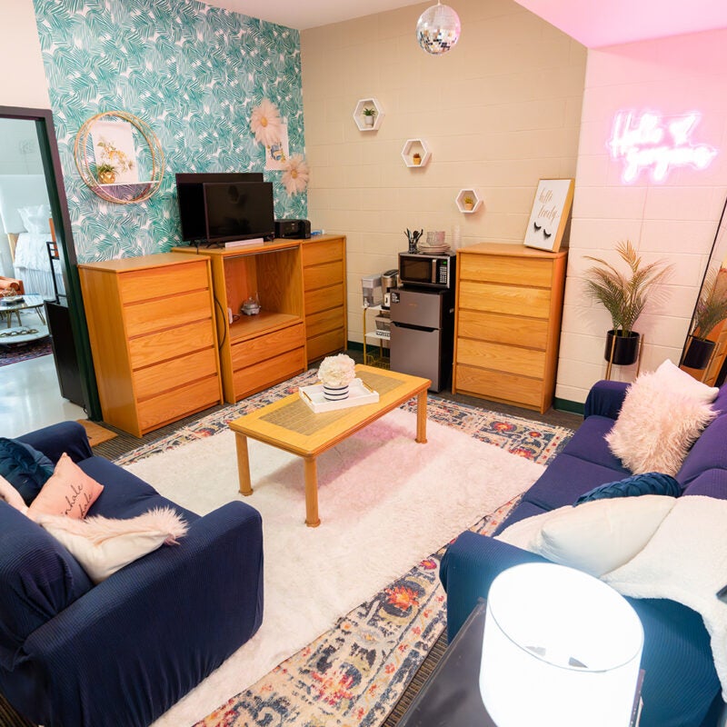 A decorated living room in a Marshall Commons suite at Marshall University