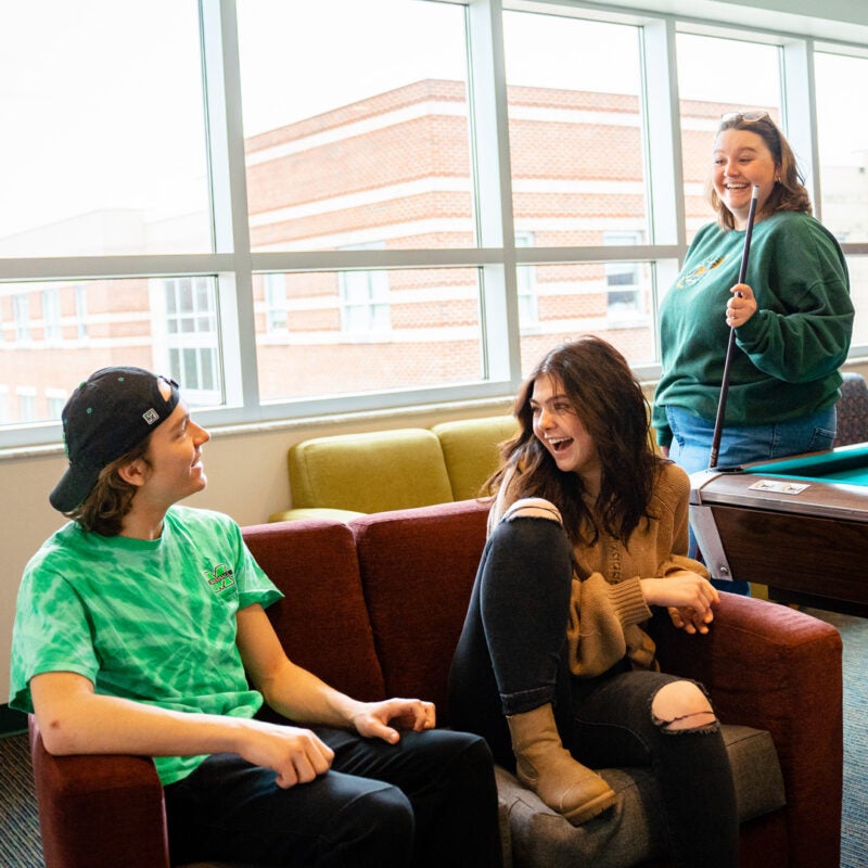 Students laugh together in a lounge at Marshall Commons