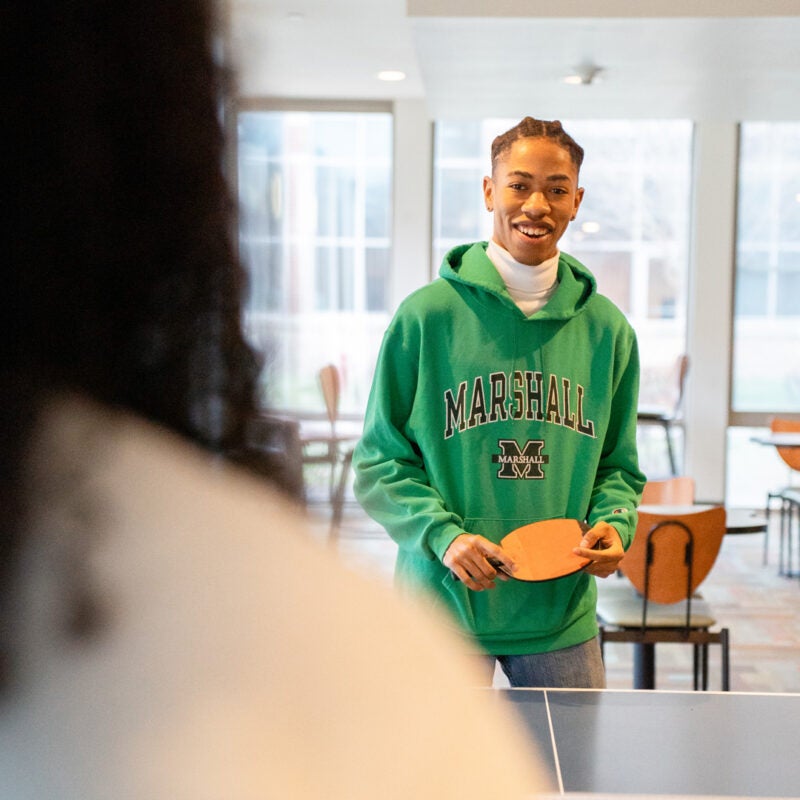 Students play games in the residence hall lounge