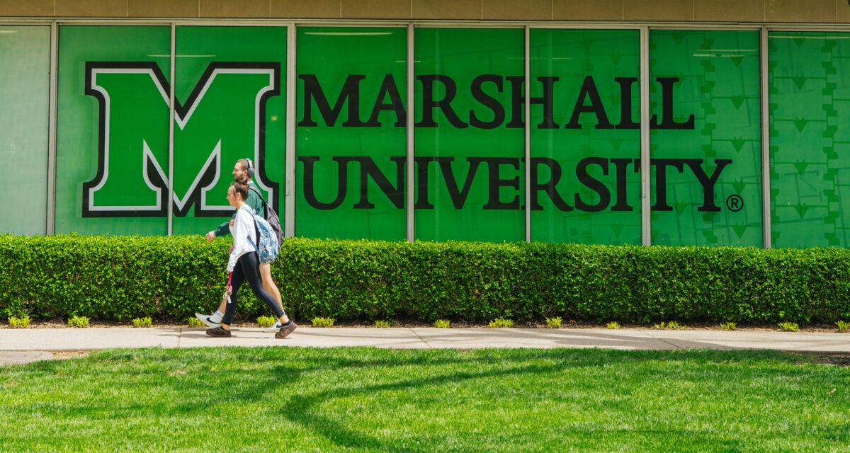 Students walk outside of Buskirk Hall on Marshall University's Huntington campus