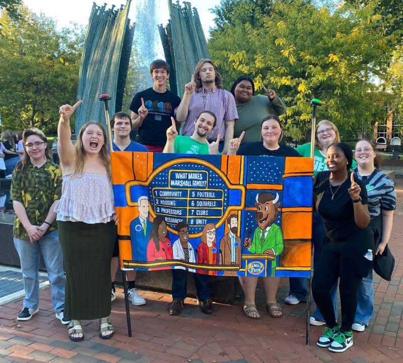 Marshall University RHA students smile together with their Unity Walk banner.