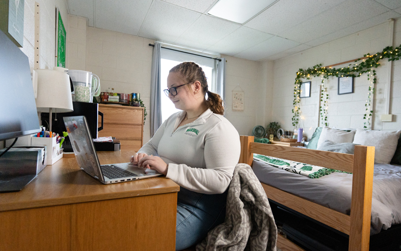 A student studies in a residence hall at Marshall University