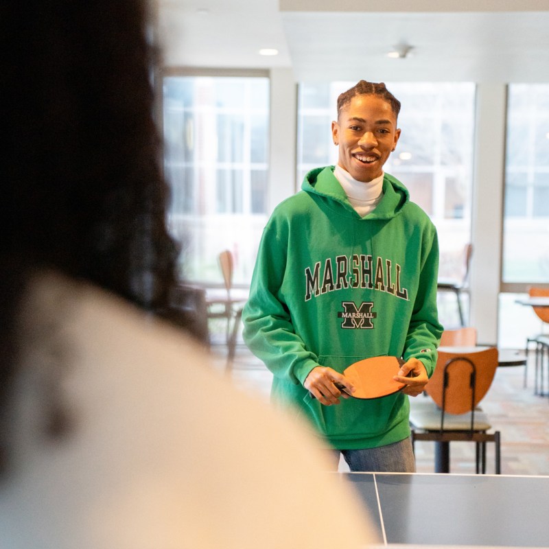 Students play games in the residence hall lounge