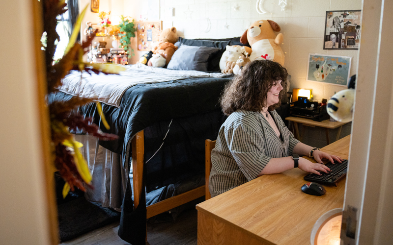 A student studies in a residence hall room in Marshall's Twin Towers