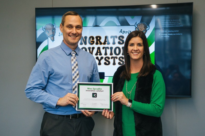 Wes Spradlin receiving a certificate from Tricia Ball