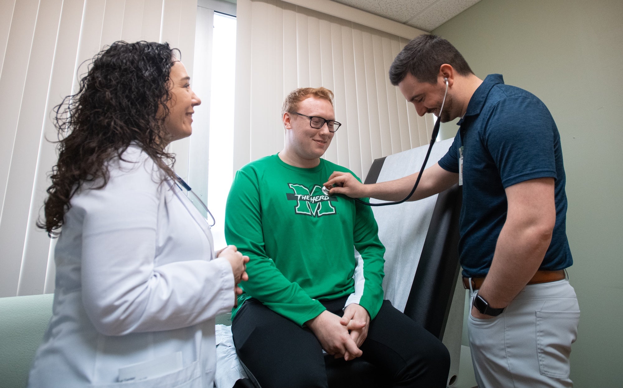 student at a doctor's appointment getting their heartbeat checked