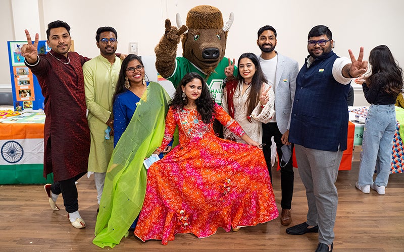 International students smile with Marshall University's mascot, Marco at an Annual International Festival
