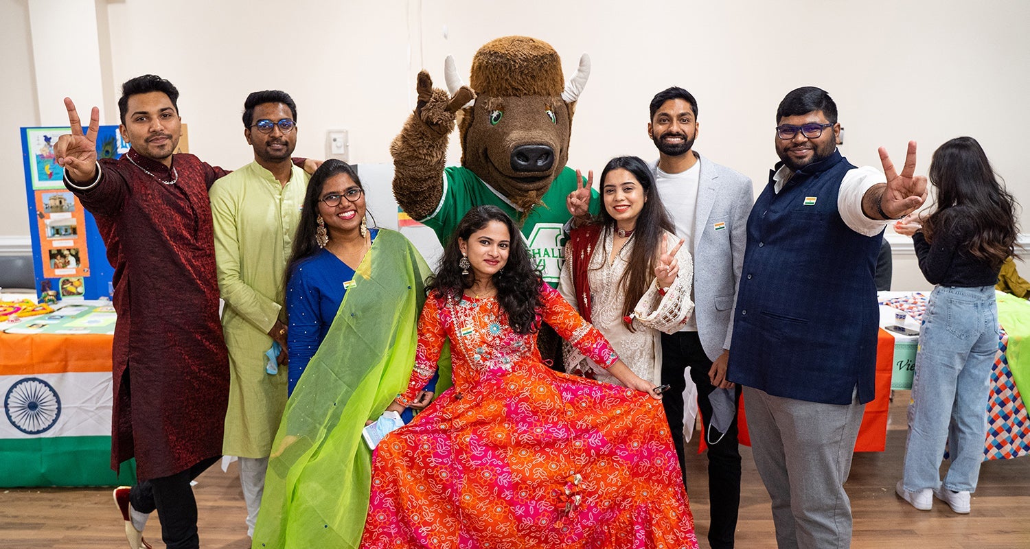 International students smile with Marshall University's mascot, Marco at an Annual International Festival