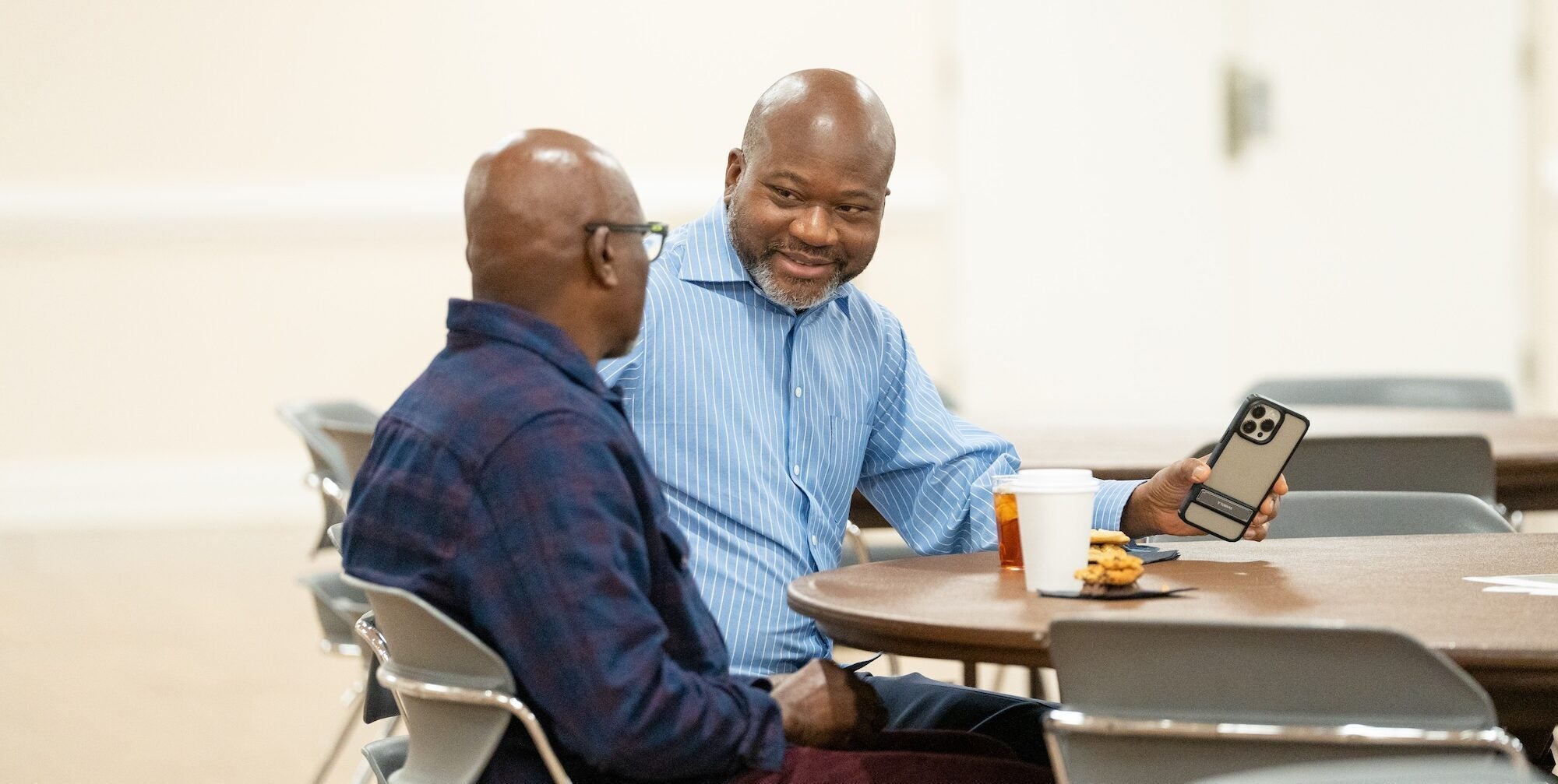 two professors talking at a table