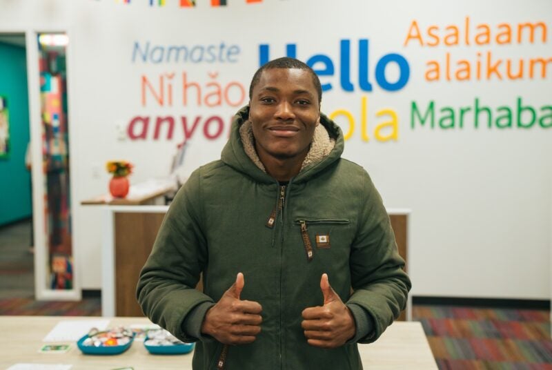 student thumbs up at the camera