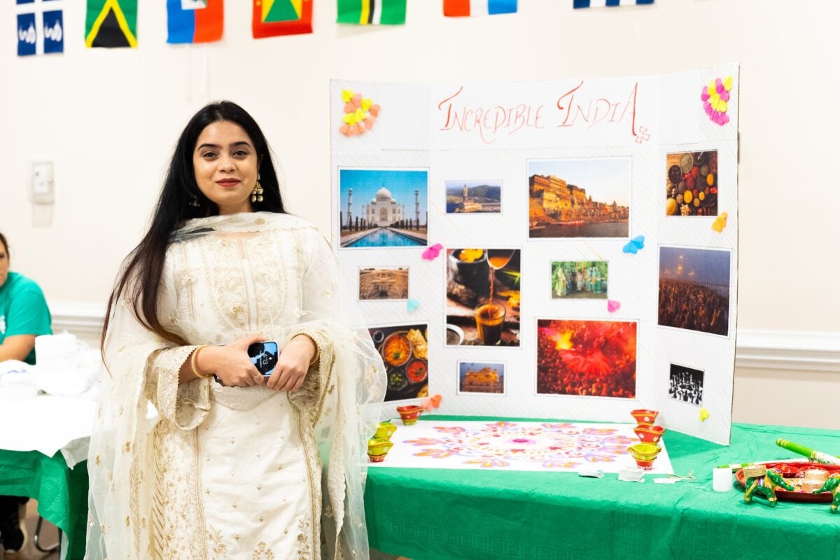 student with a presentation board in a dress