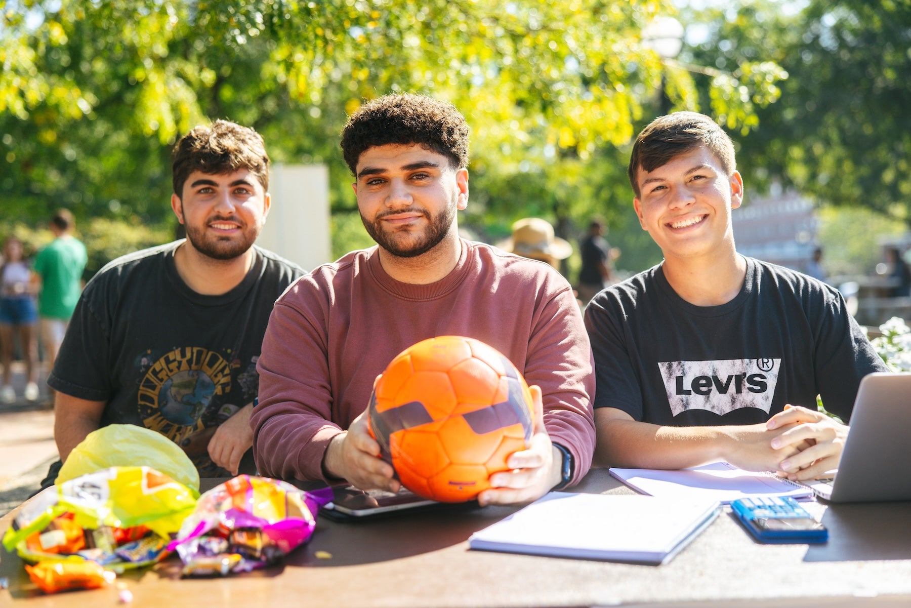 three students on the Memorial Student Center Plaza for a student organization fair