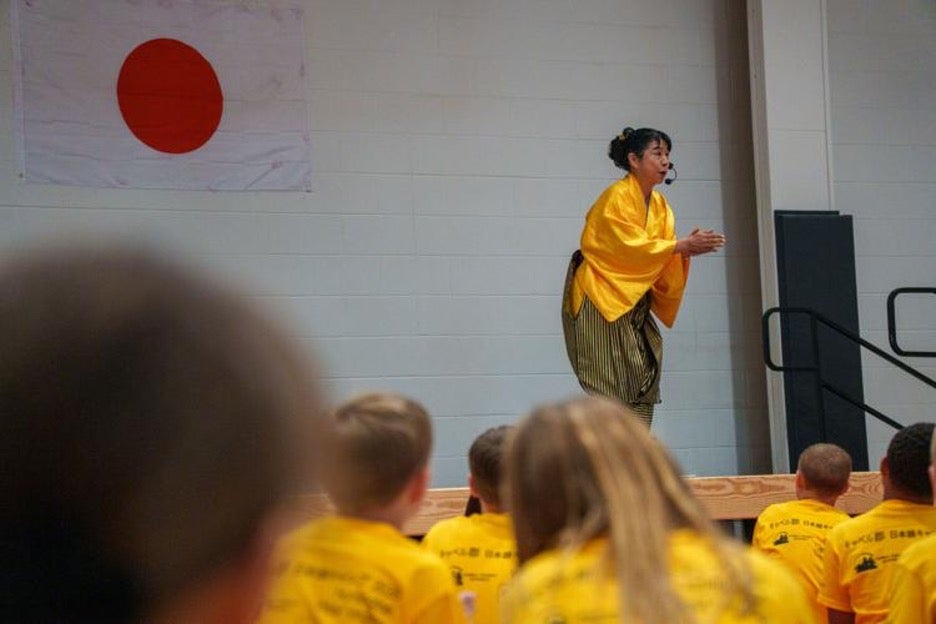 Image of Japanese Immersion camp instructor on stage.