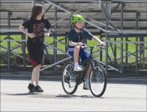 Volunteer Evan Gooding follows along as Brady McCloud pedals with ease. ‘Lose the Training Wheels’ helps participants gain valuable motor skills, as well as benefit them socially by promoting peer inclusion.