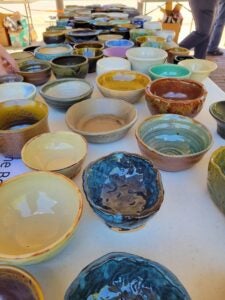 A table full of handmade ceramic bowls. 