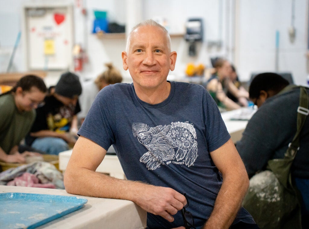Frederick Bartolovic in front of his pottery students.