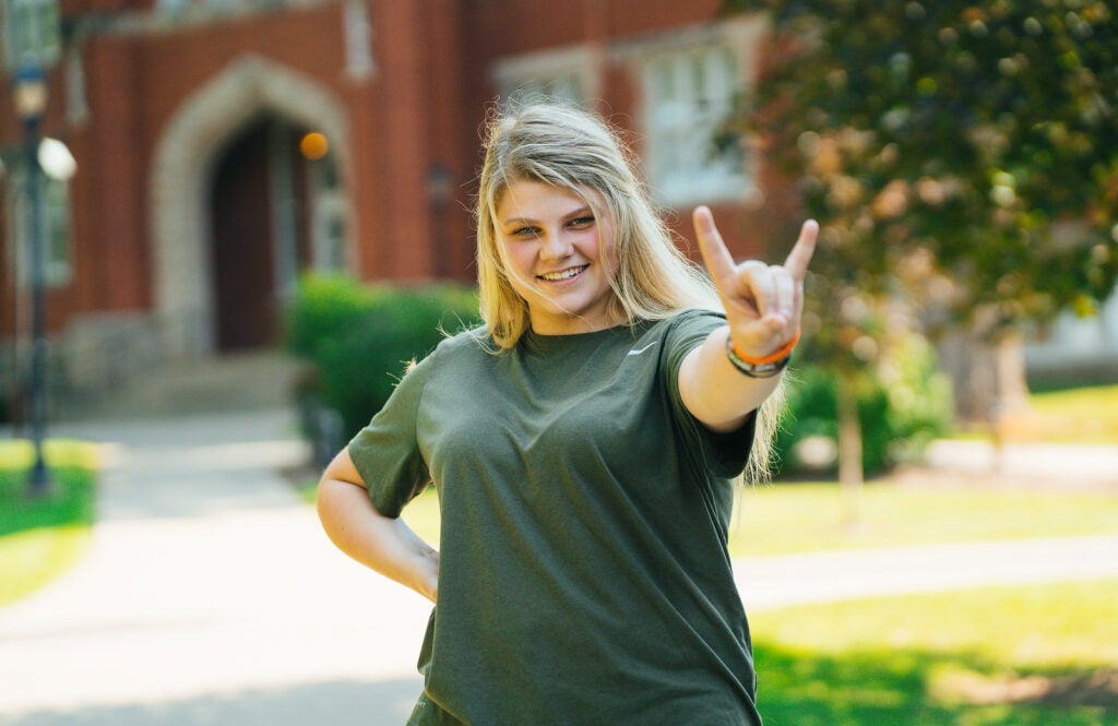 Skyla Hilliard in front of Old Main on Marshall University's campus.