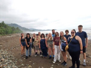 Course participants smile together on a beach on their way to Osa Conservation