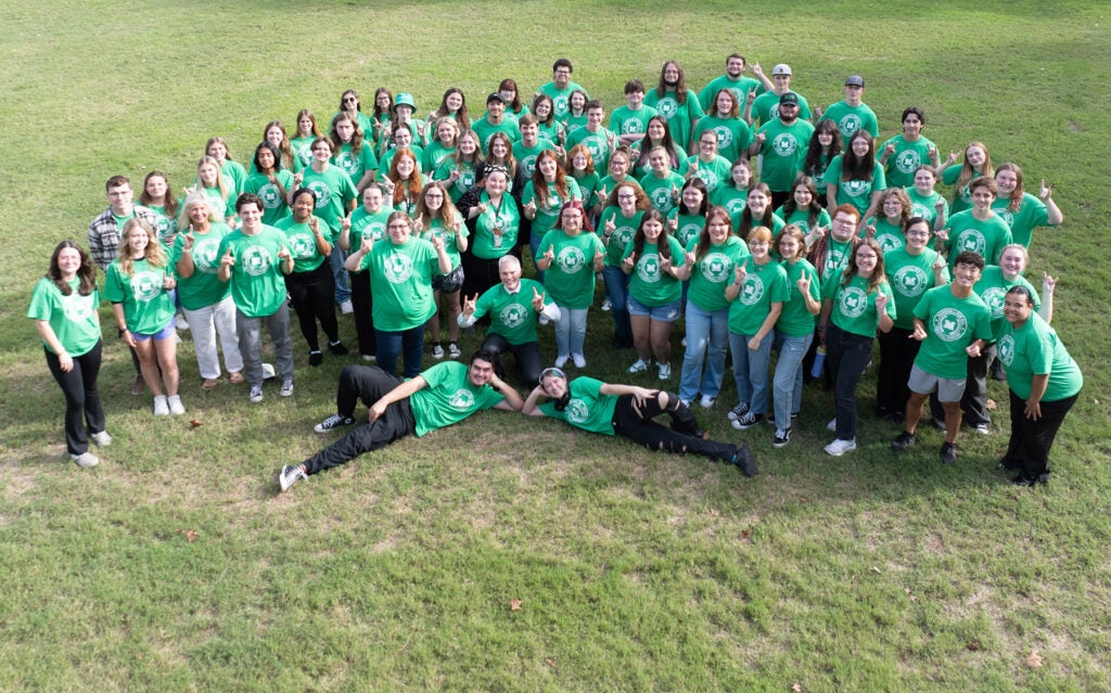 Marshall For All students pose together for a photo with President Brad D. Smith