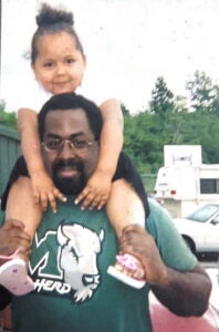 Kay Steele on her father's shoulders as a child