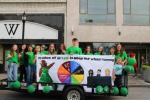 group of students on a homecoming parade float