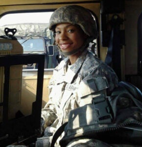 Andrea Gray wears US Army uniform while inside a military vehicle.  