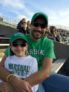 Asha Bora at a Marshall football game with her father when she was a child