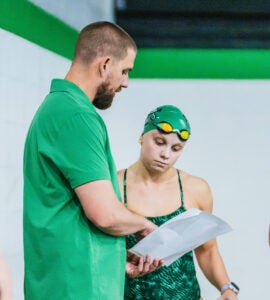 Ian Walsh, Head Coach of Marshall Swimming and Diving, talks to a swimming during practice.