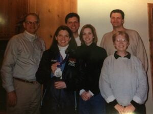 Lea Ann Parsley –Davenport holds her Olympic medal and smiles with her family