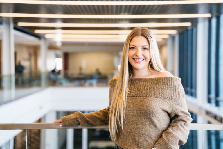 Makenzie Grandon stands in Marshall University's Brad D. Smith Center for Business and Innovation