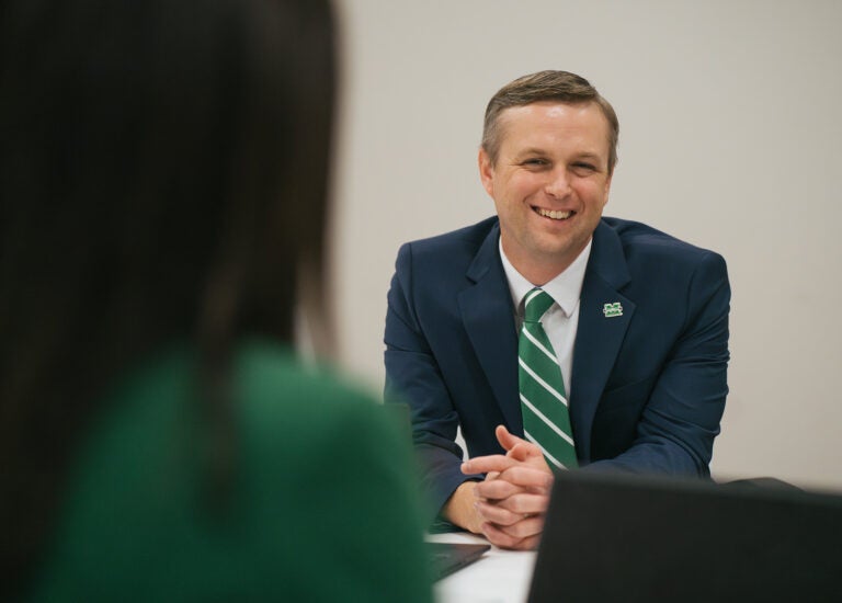Brandon Dennison, Vice President of Economic and Workforce Development at Marshall University smiles during a tabletop discussion
