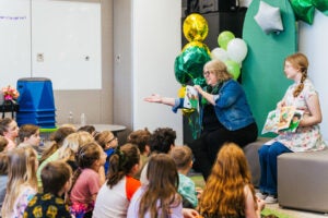Author Michelle D. Callanta reads her book, Let's Cheer with Marco to a classroom of elementary students