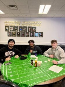 Jakob Tipton sits with friends at a campus event. 