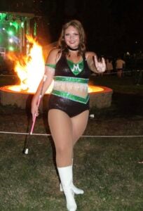 Emily Price stands in her majorette uniform at Marshall University's Homecoming Bonfire