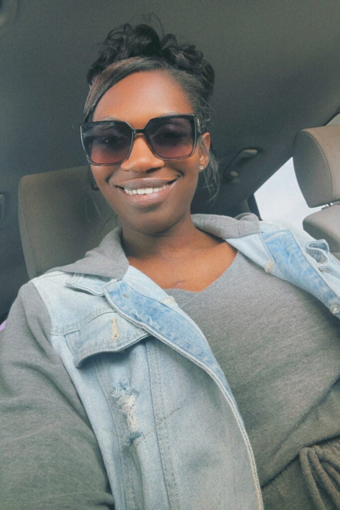 Nekesha Cabbell smiles for a selfie in her car