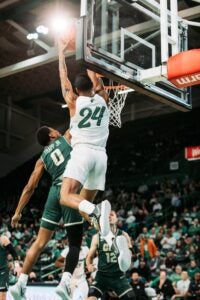 Image Kinsey dunking over Charlotte player