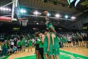 image of Kinsey dunking over teammates