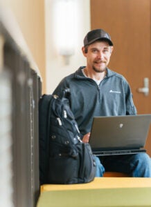 Brandon Adams works on his laptop in Marshall University's Engineering Complex