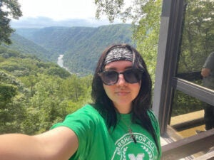 Kayleigh Garcia takes a selfie from an overlook above the New River Gorge 