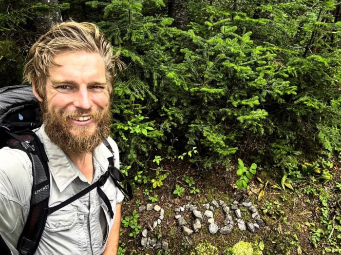 Daniel Parlock near the 2,000 mile marker in the forested, rocky terrain just before the Crocker Mountains in Maine.