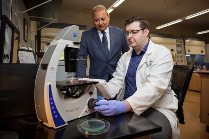 Dr. Jagan Valluri oversees Logan Lawrence in the lab